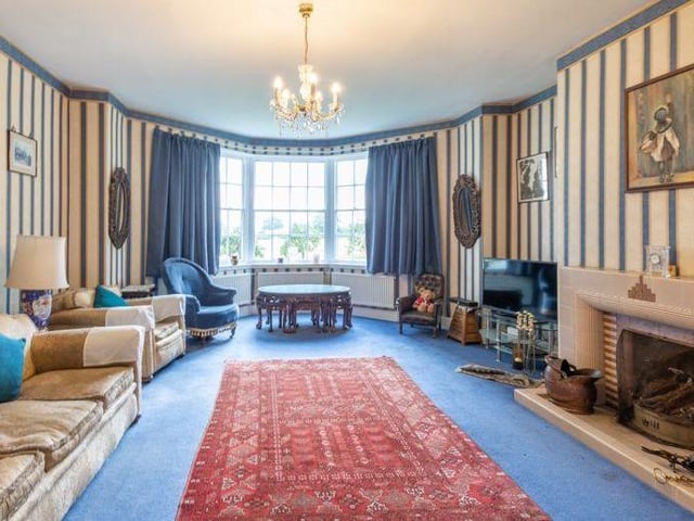 If there is one room that sums up how characterful the East Stoke property is, it's this lovely, long lounge. It includes a feature fireplace and a bay window.