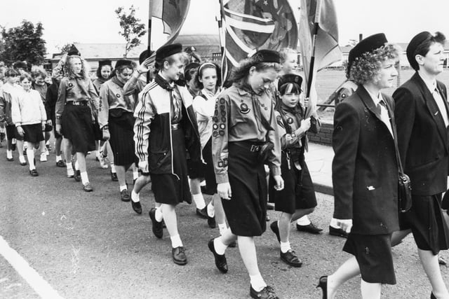 Girl Guides march under their banners en route to St Paul's Church in June 1990.