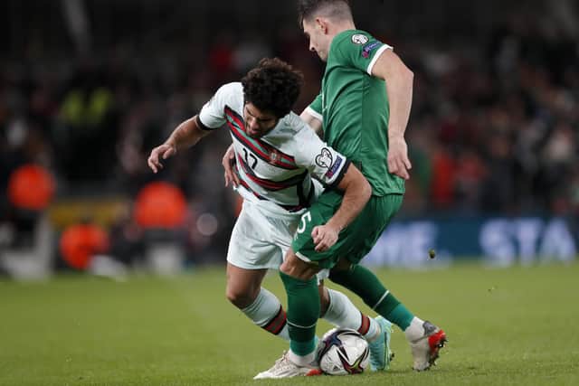 Republic of Ireland's John Egan fights for the ball with Portugal's Goncalo Guedes, left, during the World Cup 2022 group A qualifying match at the Aviva stadium. (AP Photo/Peter Morrison)