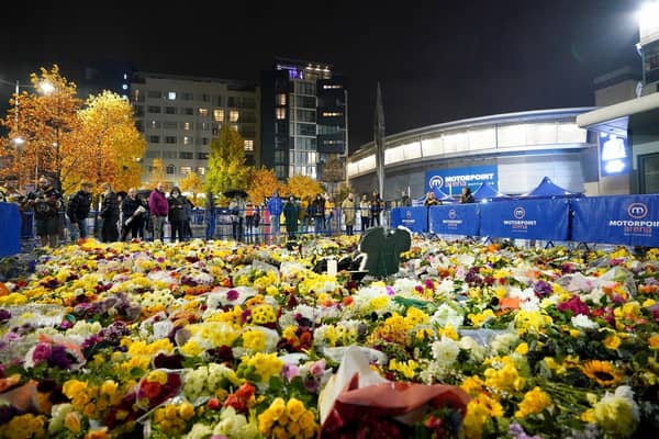 Fans look at floral tributes outside the Motorpoint Arena, Nottingham, ahead of a memorial for Nottingham Panthers' ice hockey player Adam Johnson. Adam Johnson died after sustaining an injury during a Challenge Cup match with Sheffield Steelers. (Picture: Zac Goodwin/PA Wire)