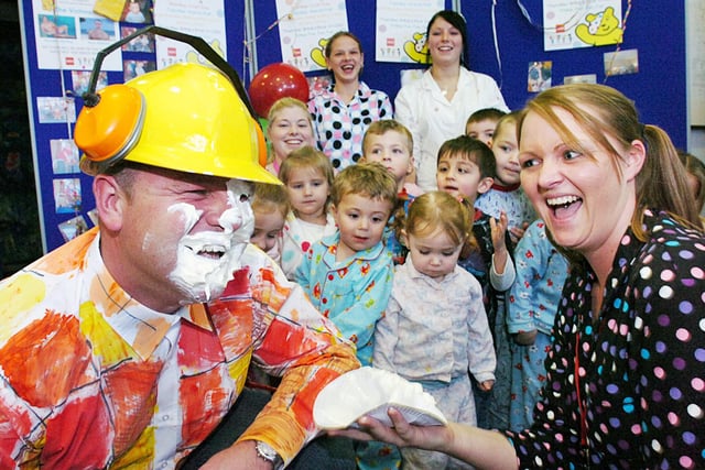 Sean Davison, dressed as Bob the Builder, takes a custard pie in the face from nursery worker Marie Hunter at the Pallion Springboard Nursery's Children In Need event in 2007.