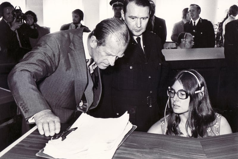 Picture shows HRH the Duke of Edinburgh taking a keen interest in the work done by control room assistant, Kathleen Lockwood, when the Duke accompanied by Her Majesty the Queen on a tour of the new South Yorkshire Police HQ in Sheffield - 29th July 1975