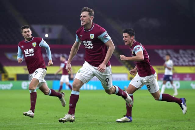 BURNLEY, ENGLAND - JANUARY 27: Chris Wood of Burnley celebrates with team mates (L - R) Matthew Lowton and Ashley Westwood after scoring their side's third goal during the Premier League match between Burnley and Aston Villa at Turf Moor on January 27, 2021 in Burnley, England. Sporting stadiums around the UK remain under strict restrictions due to the Coronavirus Pandemic as Government social distancing laws prohibit fans inside venues resulting in games being played behind closed doors. (Photo by Molly Darlington -
