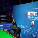 Yan Bingtao of China plays a shot during the 2021 Betfred World Snooker Championship at The Crucible, Sheffield (photo by Zac Goodwin - Pool / Getty Images).