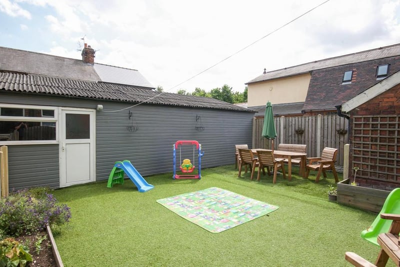 There is a low maintenance, enclosed rear garden with garden room/workshop.