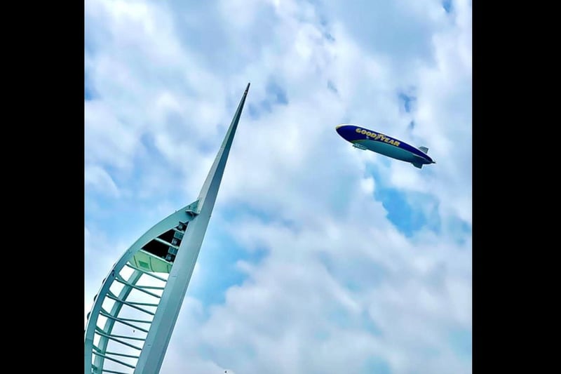 The Goodyear Blimp flies over Gunwharf Quays and the Spinnaker Tower. Picture: Lee Davey