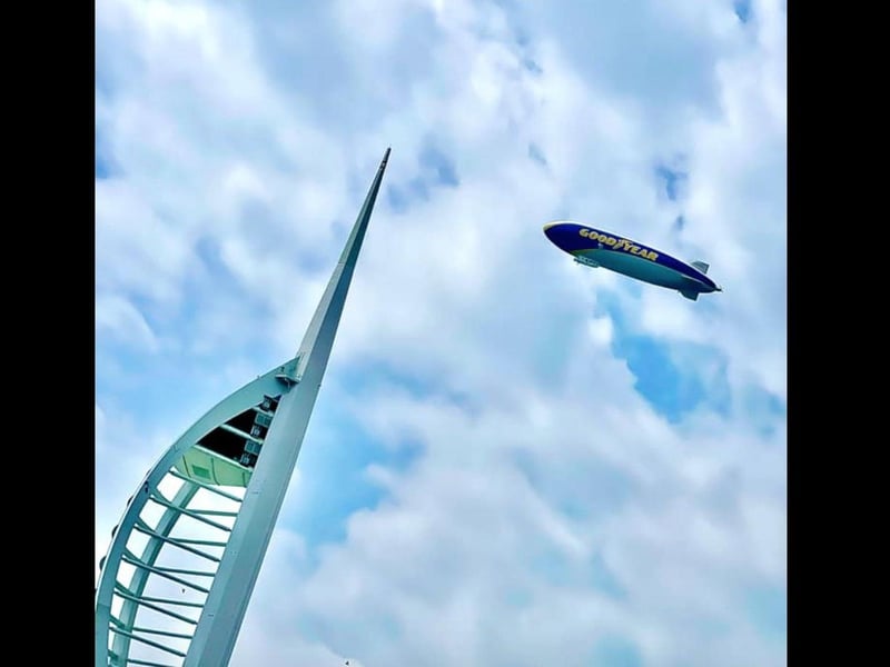 The Goodyear Blimp flies over Gunwharf Quays and the Spinnaker Tower. Picture: Lee Davey