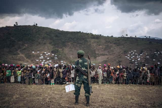 A Congolese army soldier stands guard during an official visit to the internally displaced persons camp of Bijombo