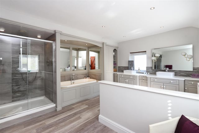 The master en-suite has a walk-in shower, bath and twin vanity sinks.