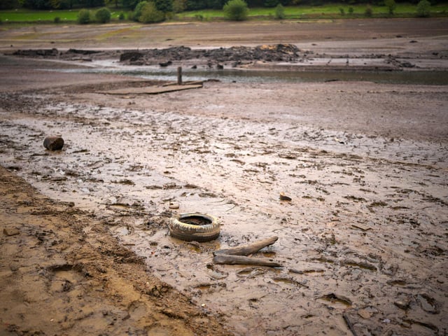 People inspect the ruins of Derwent Village, flooded in the 1940s to provide drinking water for the East Midlands and Sheffield, become exposed due to the low water level at Ladybower Reservoir and drought conditions. (Photo by Christopher Furlong/Getty Images)
