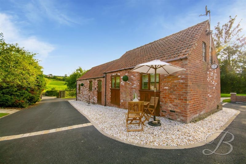 We're moving on now to the stunning, detached annexe that can be found at the top of the property's sweeping driveway. A charming building, full of character.