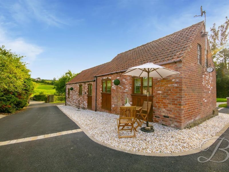 We're moving on now to the stunning, detached annexe that can be found at the top of the property's sweeping driveway. A charming building, full of character.