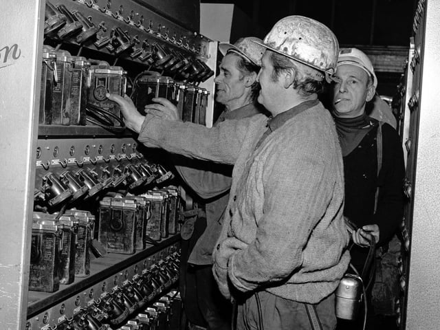 Miners at Monktonhall colliery collect their lamps from the lamphouse on one of the first shifts after the strike ended.