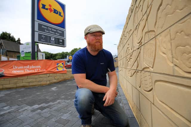 A new feature wall of the Great Flood of Sheffield that has been created at the new Malin Bridge Lidl. Pictured is Steve Roach. Picture: Chris Etchells