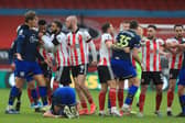 Players including Southampton's Danish defender Jannik Vestergaard (L) and Sheffield United's English-born Scottish striker Oli McBurnie (C) get involved in a melee towards the end of the game: MIKE EGERTON/POOL/AFP via Getty Images