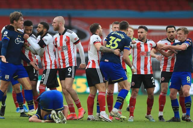 Players including Southampton's Danish defender Jannik Vestergaard (L) and Sheffield United's English-born Scottish striker Oli McBurnie (C) get involved in a melee towards the end of the game: MIKE EGERTON/POOL/AFP via Getty Images