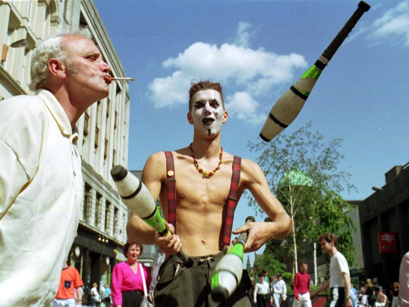 A street entertainer juggling in Argyle Street on a sunny Glasgow day in June 1992.