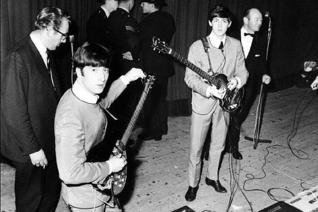 John Lennon and Paul McCartney of The Beatles on stage at Sheffield City Hall - the police presence is intriguing and probably down to Beatlemania! They played the venue several times in 1963 and 64