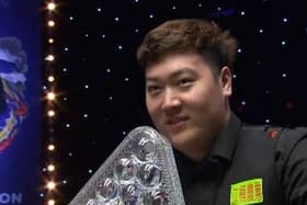 TROPHY TIME: New Masters champion Yan Bingtao with the trophy after pocketing a £250,000 cheque. Picture: Sportsbeat