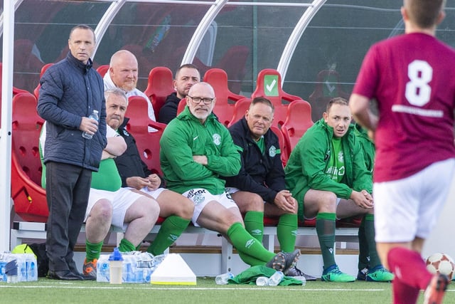 John Hughes on the Hibs bench, alongside Micky Weir (far left)