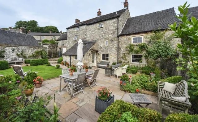 The detached period property in Brassington has a walled garden to its rear containing a paved patio, lawn and borders stocked with plants, shrubs and bushes.