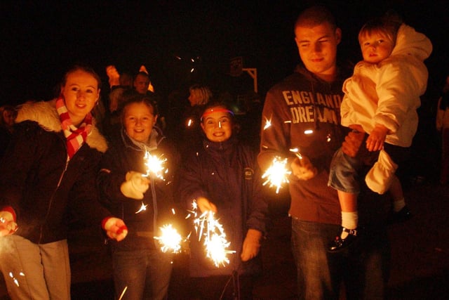 These people were enjoying all the fun of the music, fair and fireworks on Ocean Beach in 2004. Were you?