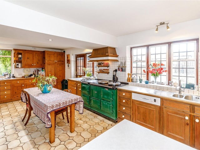The kitchen benefits from fitted units, integrated appliances, including a gas fired aga, a breakfast dining area, and a useful storage room.