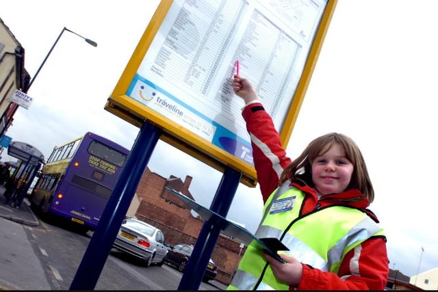 Bus stop monitor Kirsty Andrews from Bawtry inspecting a time table on St Sepulchre Gate in 2006.