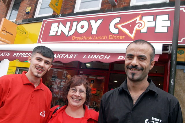 Enjoy Cafe owner Taylan Oztoprak, right and manager Diyar Tasdelen pictured with one of their regular customers Jenny Dunning outside their Sutton diner in 2009