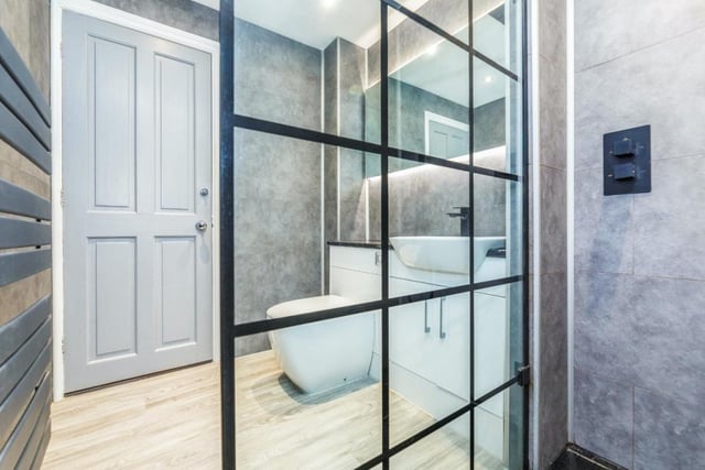 The modern family shower room features a white suite.