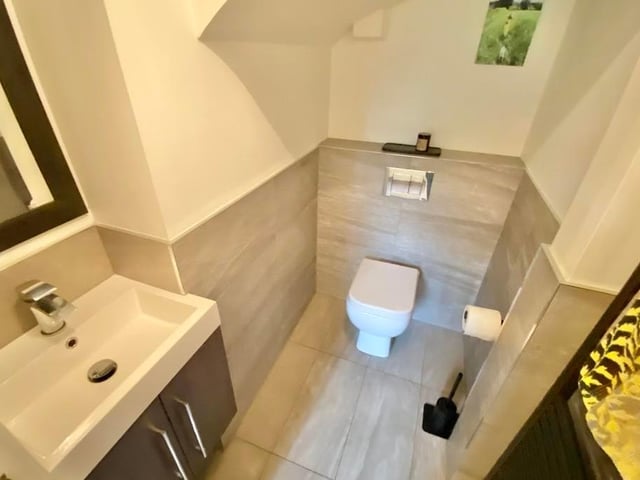 The coach-house annexe has two shower rooms. Here is the first, with shower enclosure, wash basin and low-flush WC