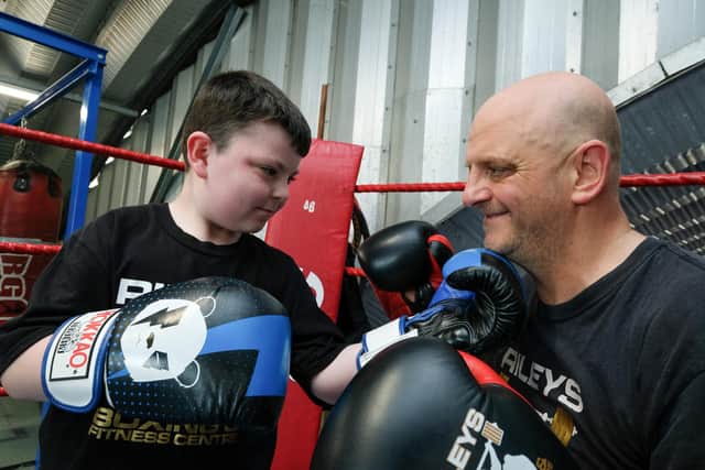 Eight-year-old boxer Lochlan Wood is holding a white collar event to raise money - with the help of Rob Riley.