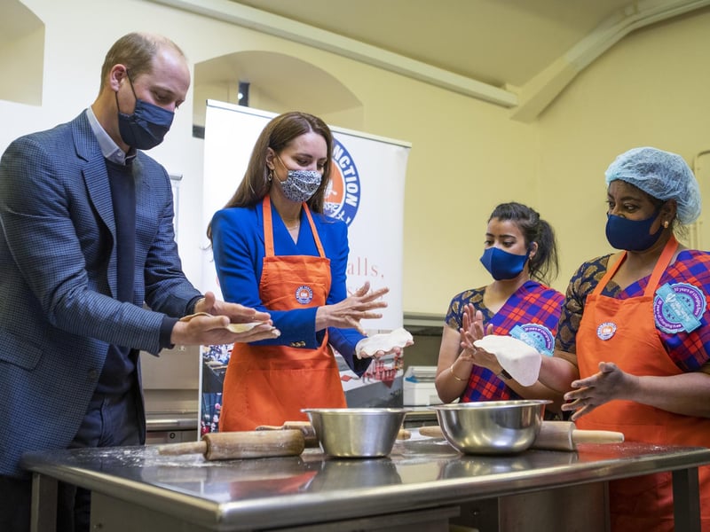 Prince William and Kate prepare meals with representatives of Sikh Sanjog, a Sikh community group, which will be distributed to vulnerable families across Edinburgh, in the cafe kitchen at the Palace of Holyroodhouse, Edinburgh on 24 May during their tour of Scotland.