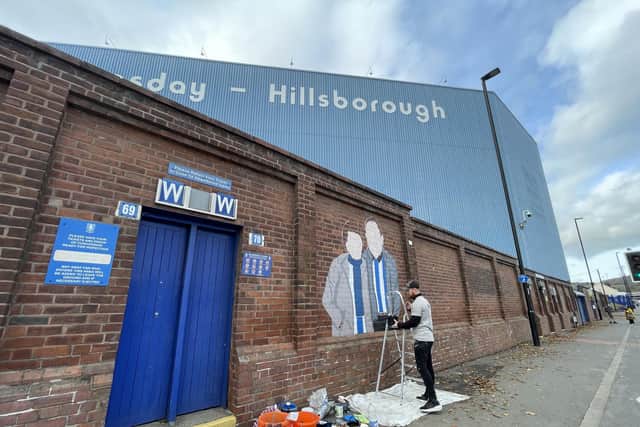 Luke Horton working on a mural outside Sheffield Wednesday's Hillsborough stadium.