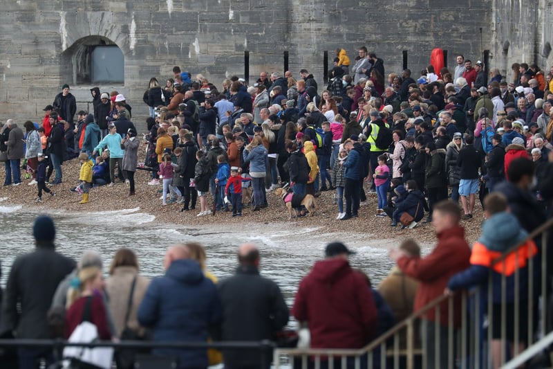 People line the shore of the Hot Walls to watch HMS Queen Elizabeth leave Portsmouth. Picture: Andrew Matthews/PA Wire