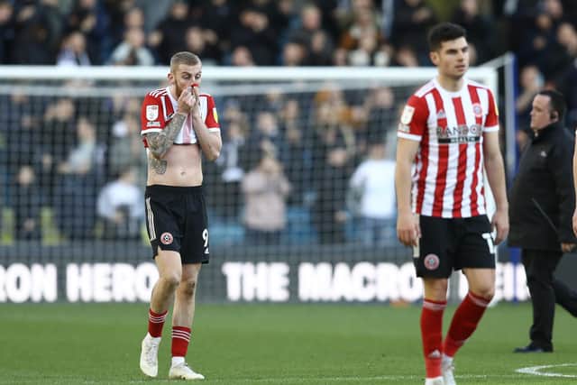 Oli MBurnie (left) looks dejected after Sheffield United's defeat at Millwall last weekend: Paul Terry / Sportimage