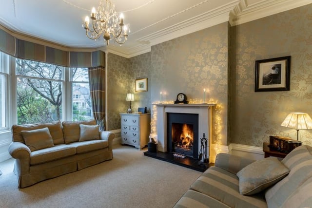 The drawing room has a front facing bay window and feature fireplace.