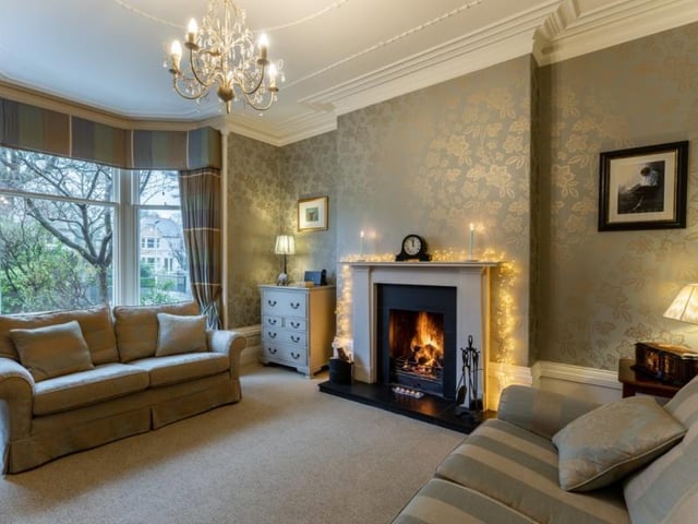 The drawing room has a front facing bay window and feature fireplace.