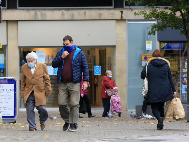 Shoppers wear face masks while in the town centre