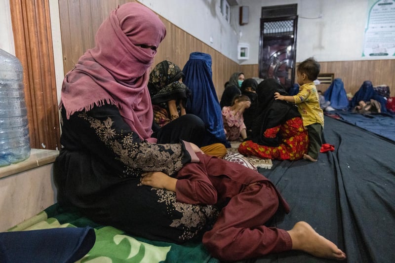 Displaced Afghan women and children from Kunduz are seen at a mosque that is sheltering them