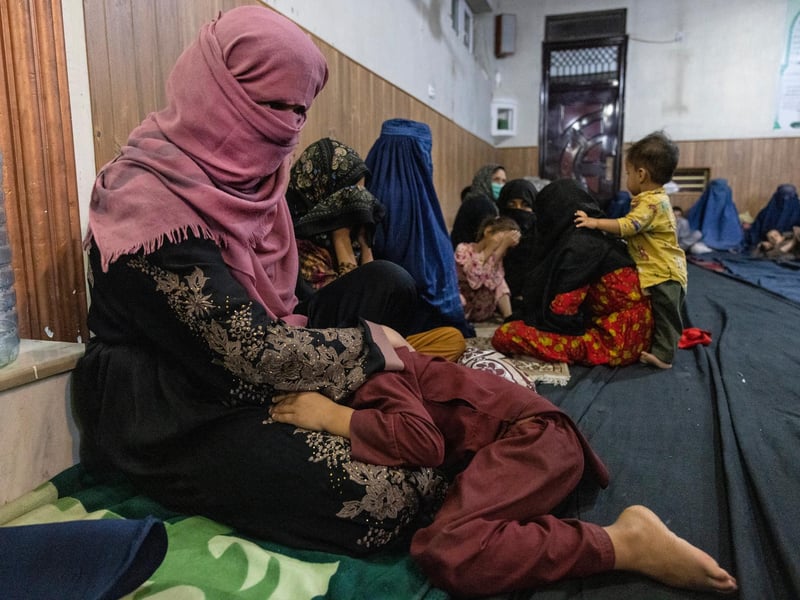 Displaced Afghan women and children from Kunduz are seen at a mosque that is sheltering them