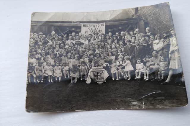 "I attach this photo for your interest. I am the little boy sitting on the front row with the cake on my left-hand side and my mother is on the right-hand side of the picture at the front" - Michael Robinson, pictured at a VE Day party on Bradfield Road, Sheffield