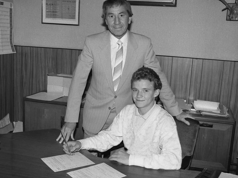 Stags sign Paul Holland, seated, with assistant boss John Jarman.