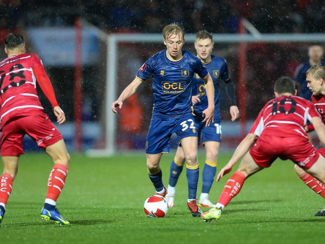 Mansfield Town midfielder George Lapslie looks for a way through the Doncaster defence.