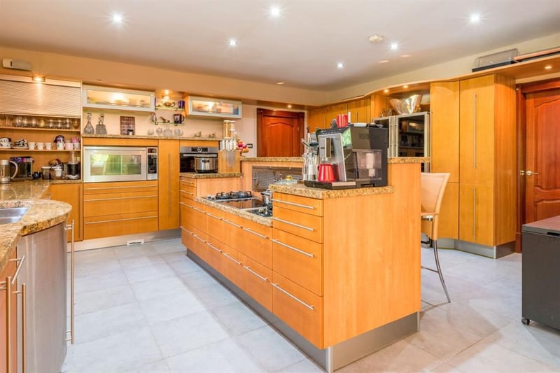 The modern breakfast kitchen benefits from stylish granite work surfaces, fitted wooden cupboard and integrated appliances, complete with a dining area with east facing French doors.