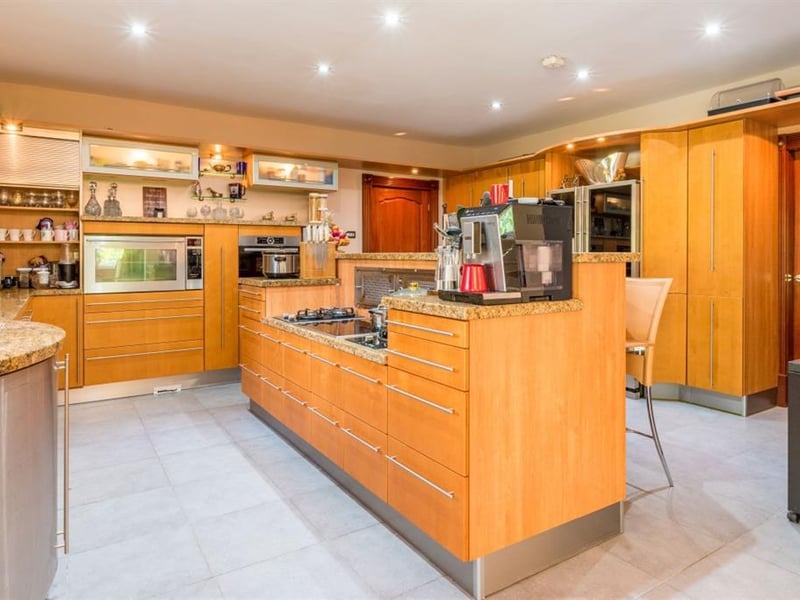The modern breakfast kitchen benefits from stylish granite work surfaces, fitted wooden cupboard and integrated appliances, complete with a dining area with east facing French doors.
