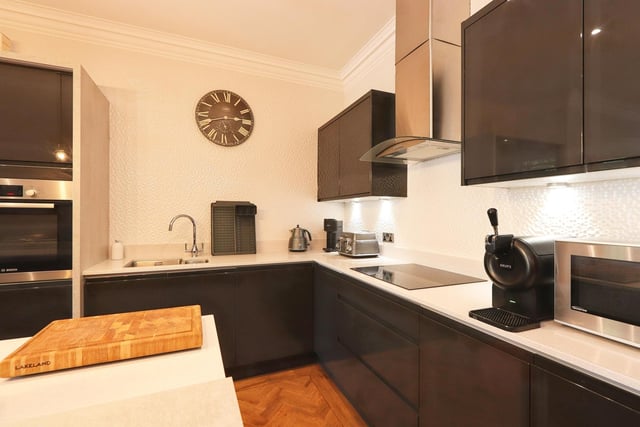 The fitted kitchen features built in appliances and offers lots of storage space.