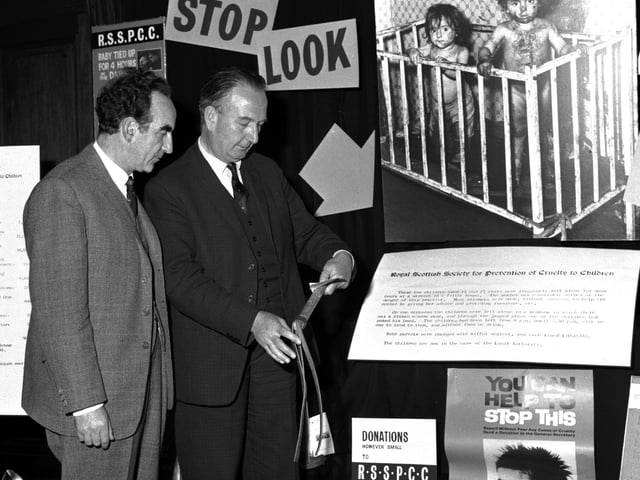Lord Wheatley and Mr Alastair Dunnett, editor of The Scotsman, discuss the 'Cruelty to Children' display in The Scotsman office in September 1965.