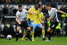 DERBY, ENGLAND - DECEMBER 03: Eiran Cashin of Derby holds off Alex Mighten of Sheffield Wednesday during the Sky Bet League One between Derby County and Sheffield Wednesday at Pride Park Stadium on December 03, 2022 in Derby, England. (Photo by Gareth Copley/Getty Images)