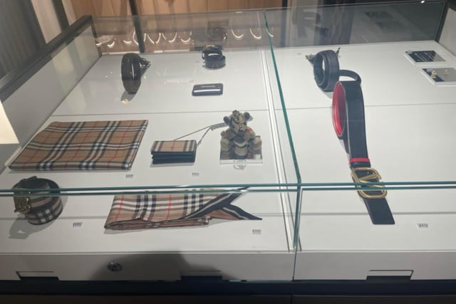 Scarves, wallets and belts all live under a glass shelf